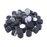 a pile of black and white foam discs