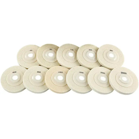 a pile of white foam polish pads