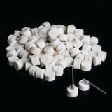 a pile of white sugar cubes on a black background