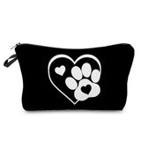 a close up of a black and white bag with a heart and paw prints