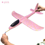 a person is painting a pink airplane