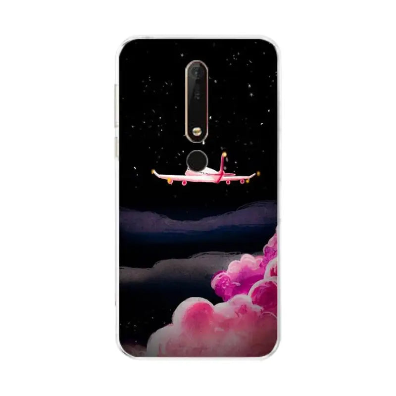 a pink airplane flying in the sky with clouds and stars on it