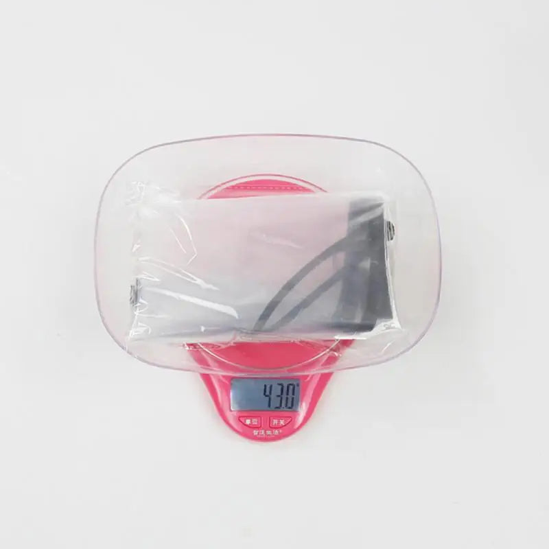 a pink alarm clock with a plastic cover