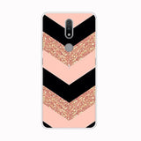 a pink and black chevrons pattern with gold glitter on the back of a phone case