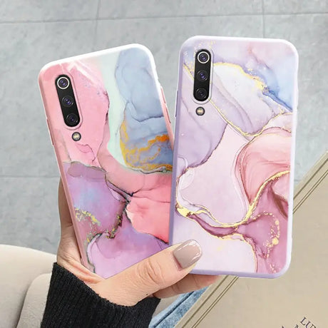 a woman holding a phone case with a marble pattern