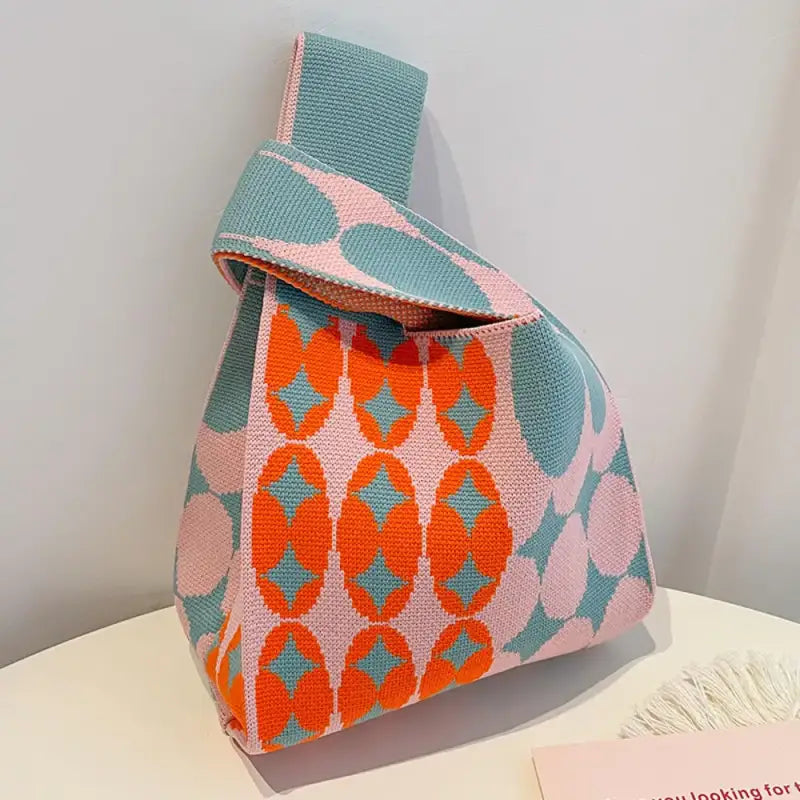 a pink and blue purse with a pink and orange pattern