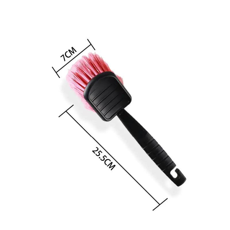 a pink brush with a black handle