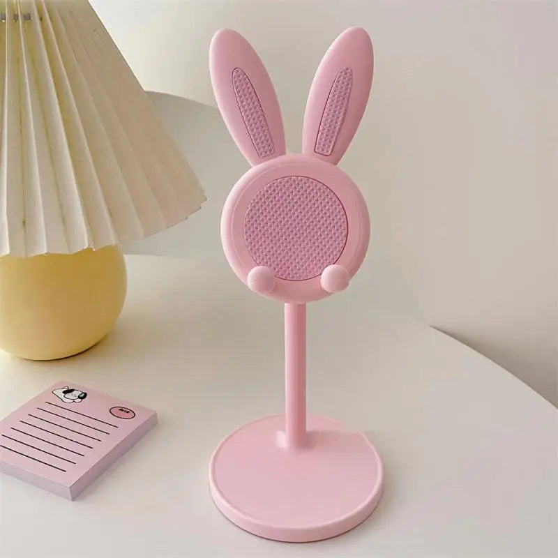 a pink bunny shaped speaker on a white table