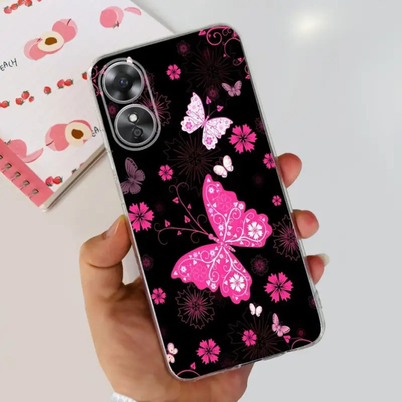 a woman holding a pink butterfly phone case