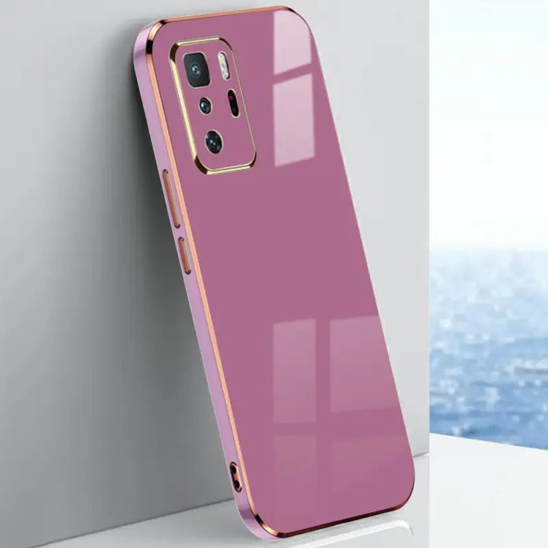 the back of a pink case with a gold ring