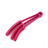 a pink plastic hair clip with a white background