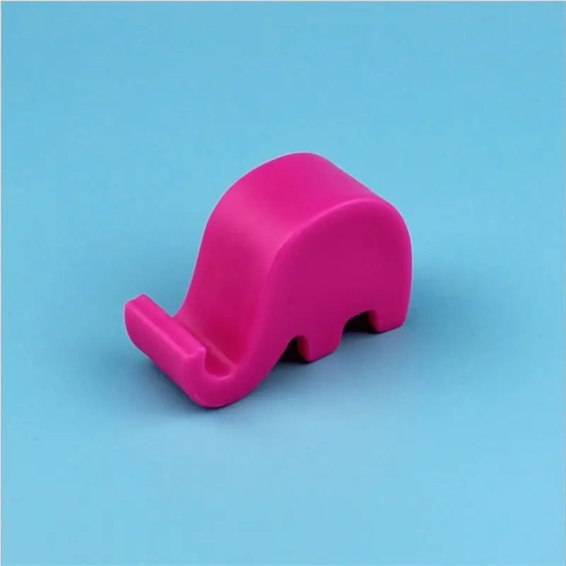 a pink elephant shaped object on a blue background