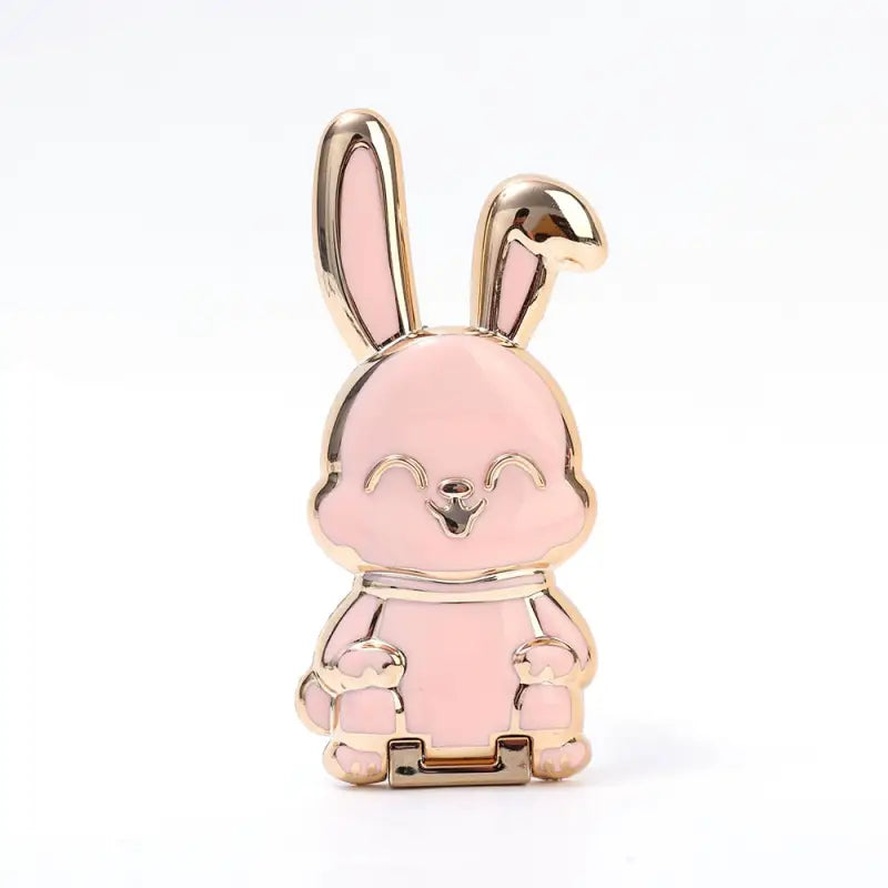 a pink enamel rabbit with a gold base