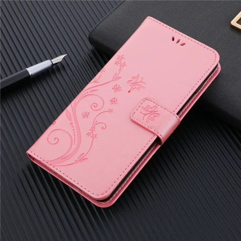 a pink leather case with a dragon design