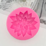 a pink flower shaped candle with a white background