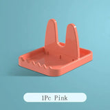 a pink plastic desk organizer with a white background