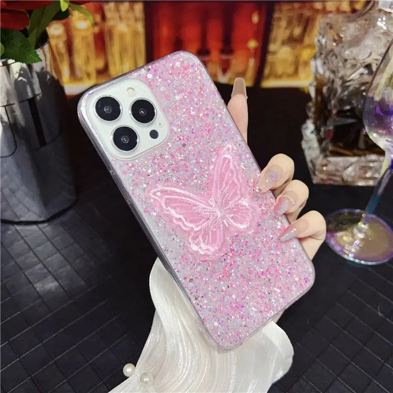 a pink glitter phone case with a butterfly design