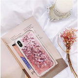 a pink glitter phone case with a flower design