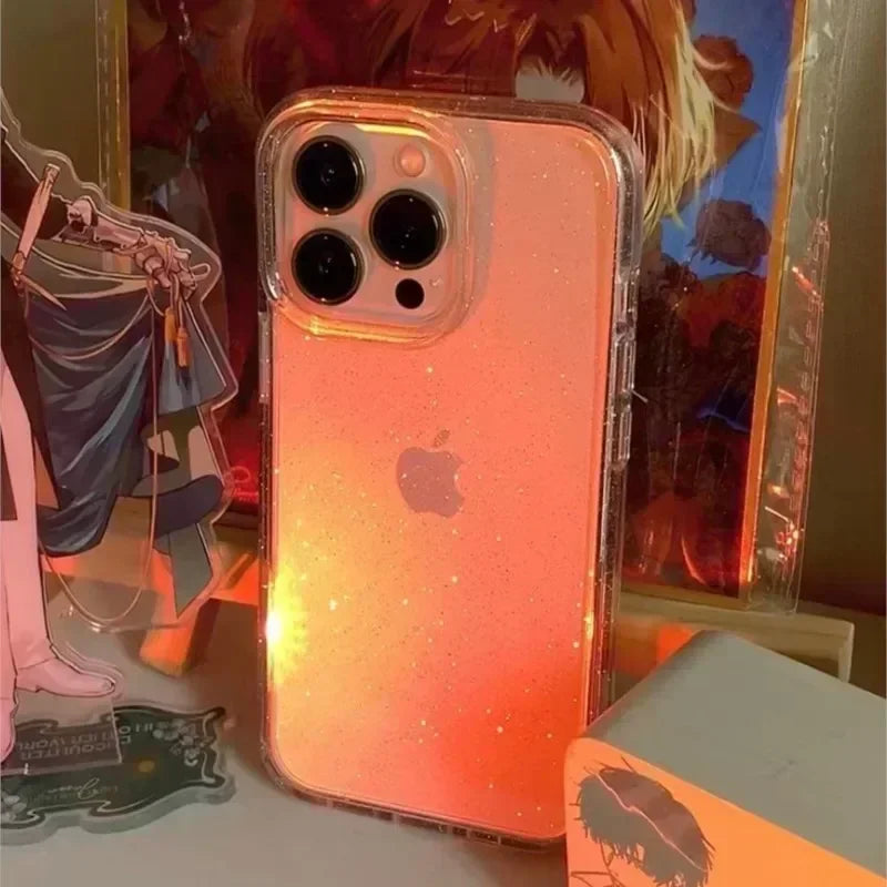 a pink glitter phone case sitting on top of a table