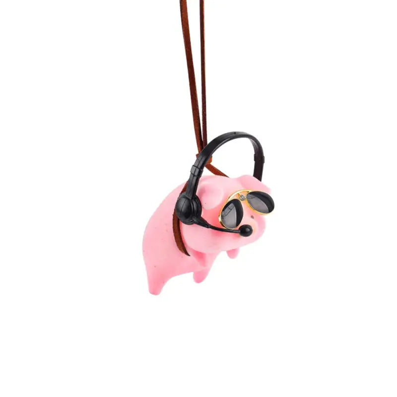 a pink pig with headphones on a brown leather cord
