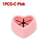 a pink heart shaped ring with a cross on it