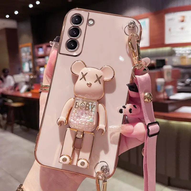 a pink phone case with a bear on it