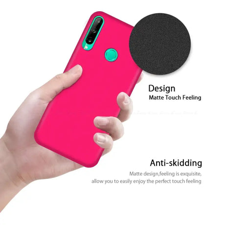 The back of a pink iphone case with a black circle on it