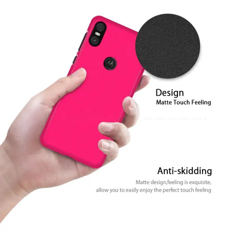 The back of a pink iphone case with a black circle on it