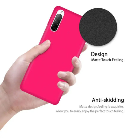 The back of a pink iphone case with a black circle on it