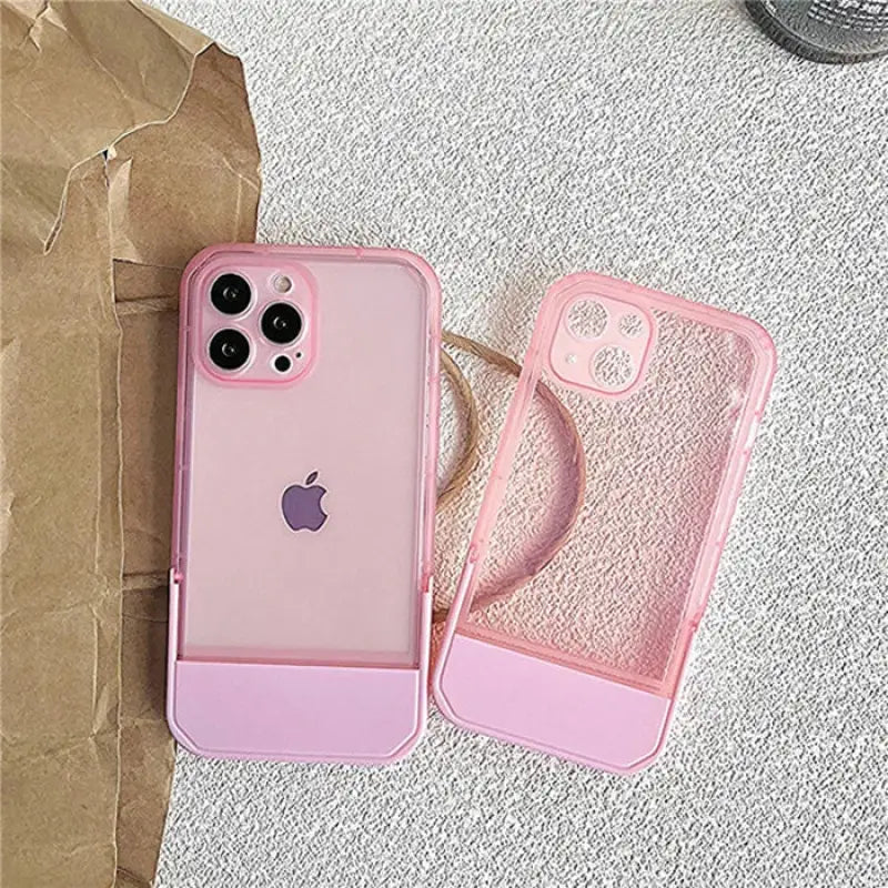 a pink iphone case sitting on top of a brown paper bag