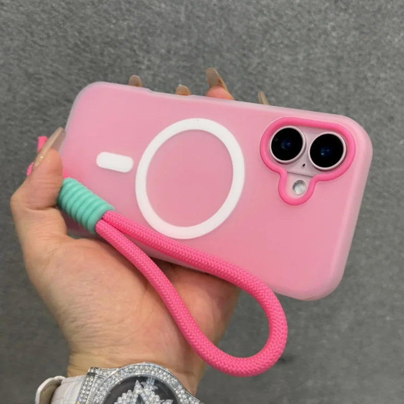 Pink iPhone case with a camera-like design and a wrist strap.
