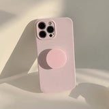 the iphone 11 case is a pink color with a circular design