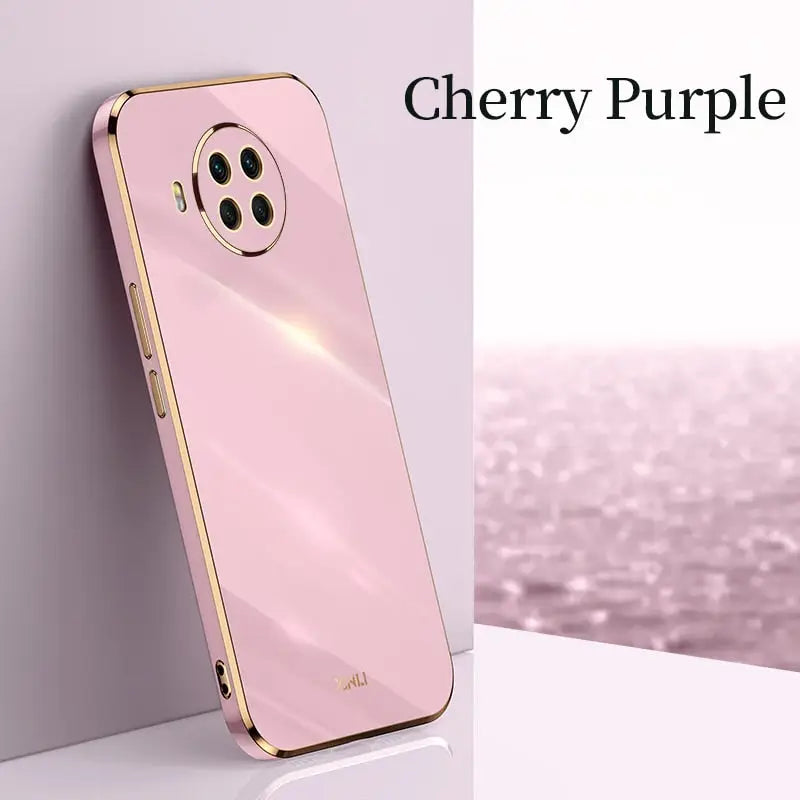 a pink iphone case with a gold rim