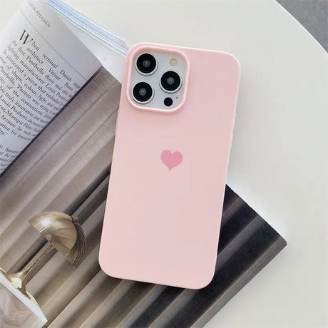 a pink iphone case with a heart on it