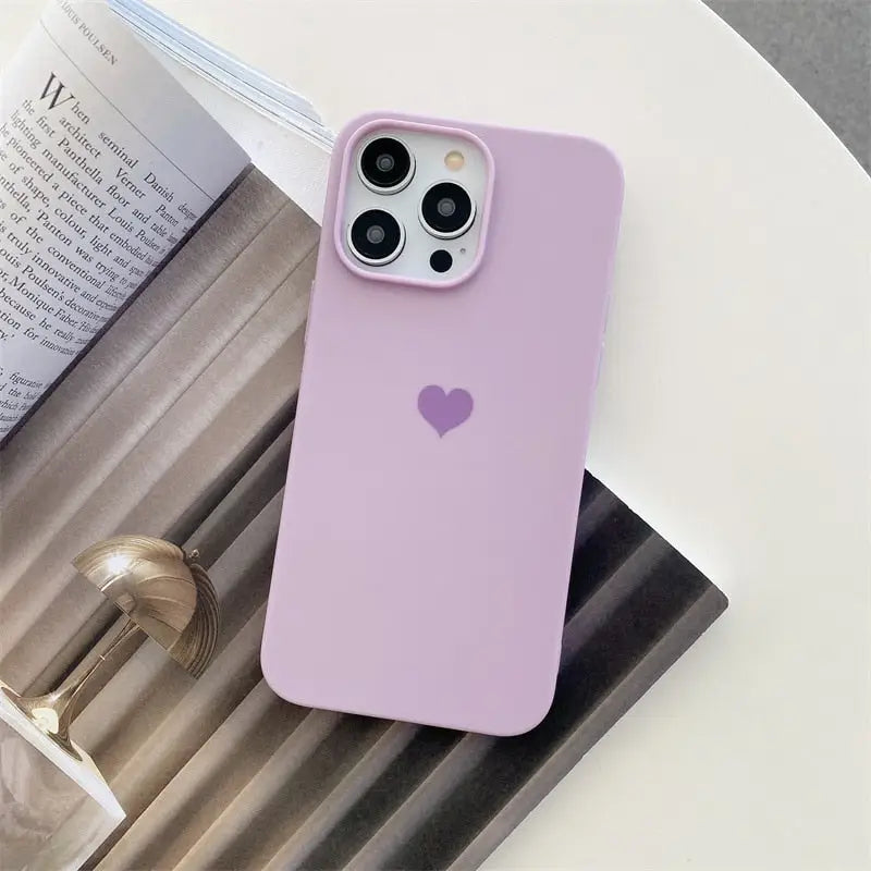 the pink heart phone case is on a table