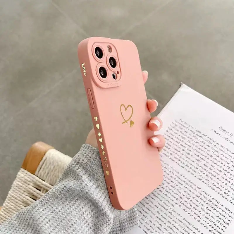 a pink iphone case with a heart on it