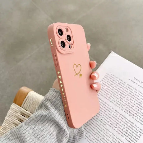 A pink iphone case with a heart on it