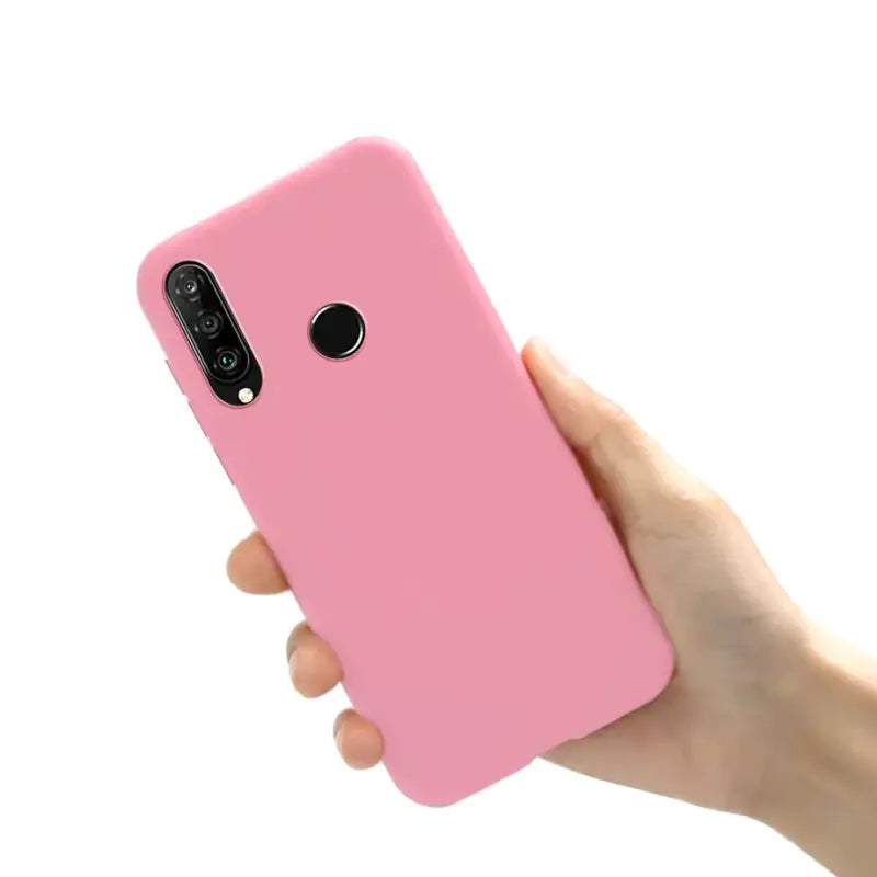 the pink iphone case is held up in a hand