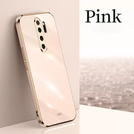 the pink iphone is displayed on a table