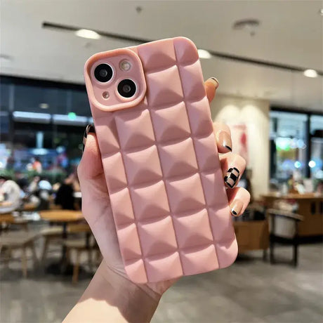 A pink iphone case with a pink quilt pattern