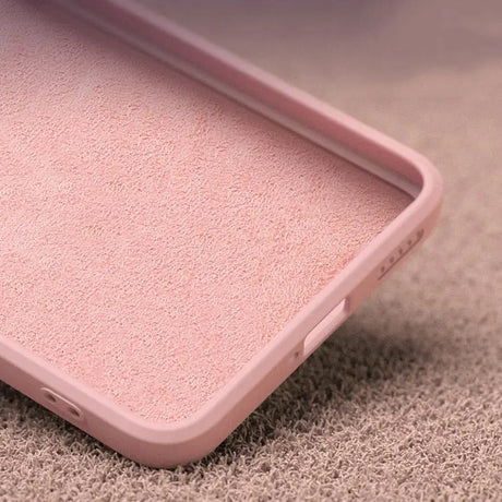 a pink iphone case sitting on a carpet