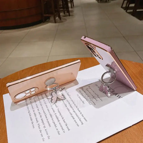 a pink iphone case sitting on top of a table