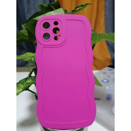 A pink iphone case sitting on a table