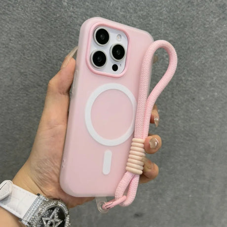 Pink iPhone case with a white MagSafe ring and a matching wrist strap.