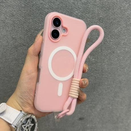 Pink iPhone case with a white MagSafe ring, a camera cutout, and an attached pink braided wrist strap.