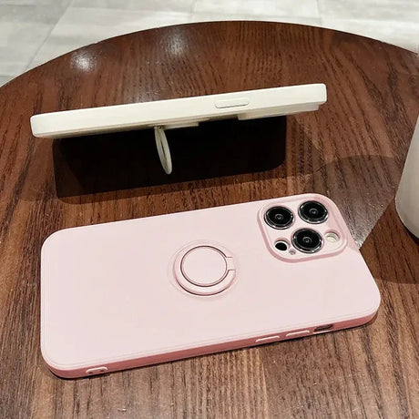 A pink iphone case sitting on top of a wooden table