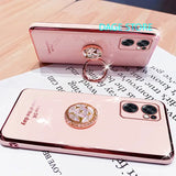 two pink iphone cases with a ring on top of them
