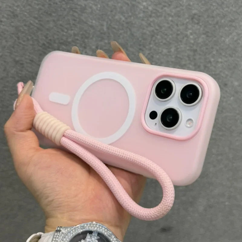 Pink iPhone with a wrist strap and MagSafe ring.