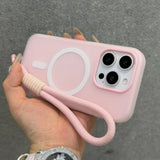 Pink iPhone with a wrist strap and MagSafe ring.
