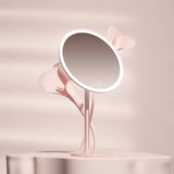 a pink lamp with a mirror on top